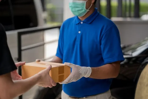 Courier handing a package to a customer