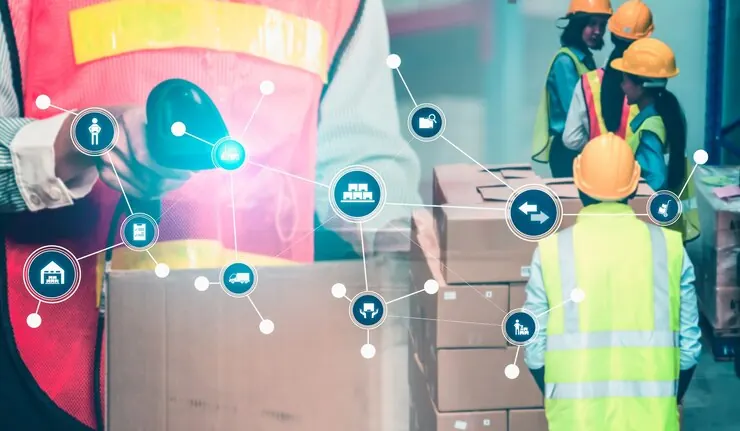 Warehouse worker reviewing shipment sustainability data